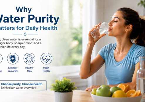 Woman drinking a glass of clean water beside healthy fruits and a water bottle, highlighting the importance of water purity for better hydration, immunity, skin health, and overall daily wellness