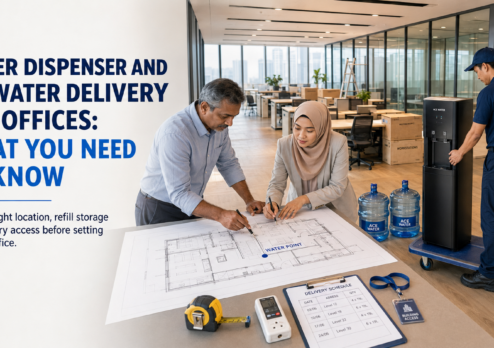 Office team planning a workplace hydration setup while an Ace Water staff member delivers a water dispenser and 19L water bottles, highlighting convenient 19L drinking water delivery for offices.